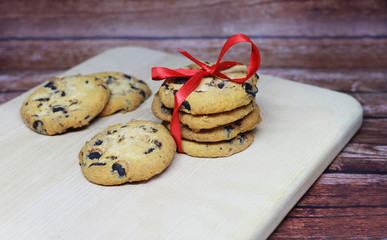 New Year  and merry Christmas , festive cookies wits pieces of chocolate with a red bow 