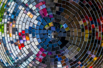 Colourful reflections in a disco ball. Party, disco concept. Disco ball reflecting abstract, vivid colors, photo from below.