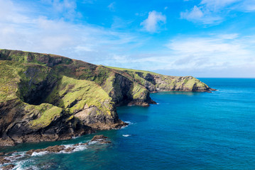 Fototapeta premium Sunlight catches the headland close to the pretty village of Port Isaac