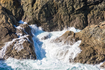 Waves crashing onto rocks of the north Cornwall coastline