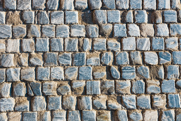 Gray stone road texture at sunny day