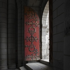 Porte ancienne en bois rouge de la chapelle d''une abbaye à Fontevraud, Pays de Loire, France.