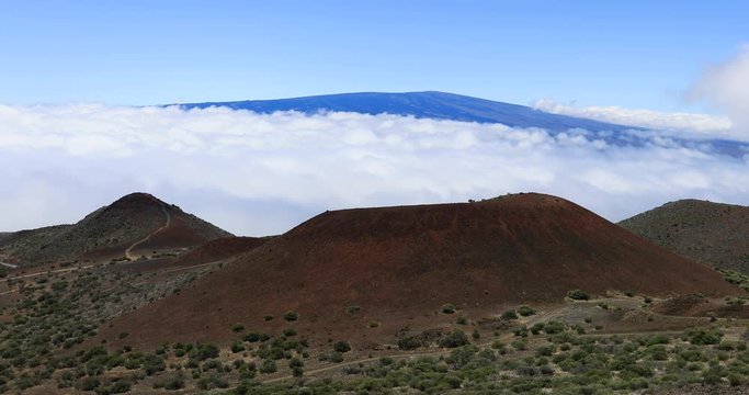 Mauna Loa volcano from Mauna Kea Hawaii above clouds fast. Most active volcano in the USA. Smoke, steam, gasses. On the Big Island in Volcano National Park.