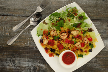 Сouscous with cheese paneer and vegetables with salad mix and tomato sauce