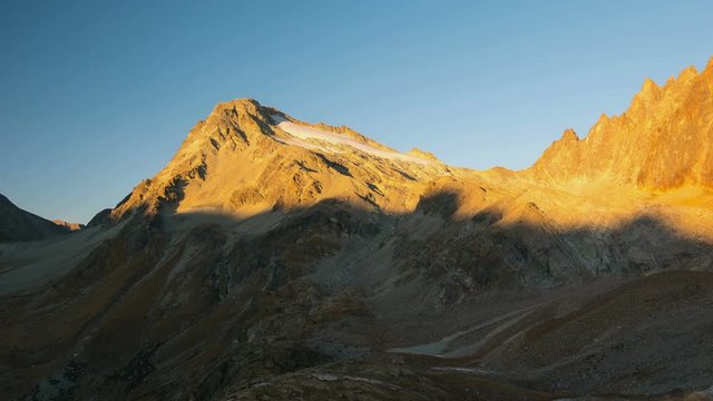 Timelapse from sunset to dusk on the the Italian Swiss Alps. Majestic mountain peak with glacier, Mont Gel&eacute; (3519 m), Aosta Valley, travel destination in Italy.