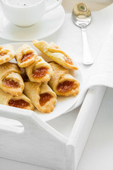 Coffee time with Polish cream cheese cookies  (Kolacky) with apple jam on white table cloth