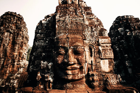 Huge carved Buddha stone faces of Bayon Temple, Angkor, Siem Reap, Cambodia. Ancient Khmer architecture. Wide angle