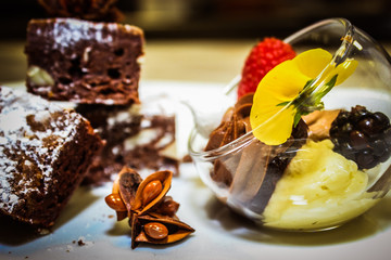 Delicious chocolate desserts with fruits and flowers.