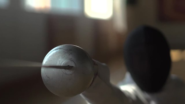 Fencer attacks in the gym