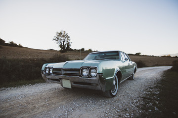 Vintage car parked on rural road