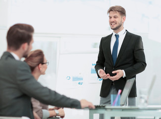 Successful business man in suit at the office leading a group