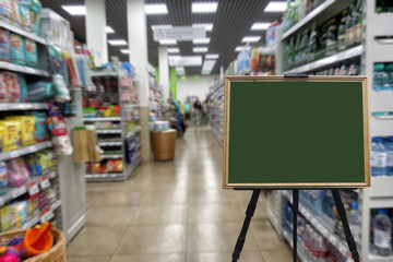 Supermarket, shelves with goods. Defocused image. Place in a wooden frame for your text or advertisement.