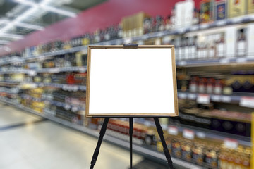 Alcohol department in the supermarket. Shelves with bottles. Defocused image. Place for your text or advertisement.