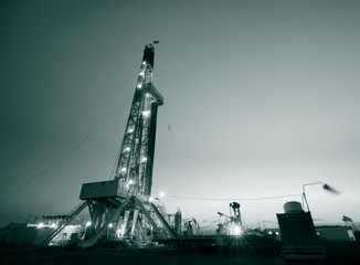 In the evening, the silhouette of oilfield derrick
