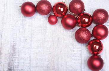 Red christmas balls on a wooden background