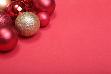 Red christmas balls on a red background