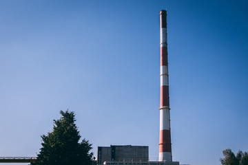 Factory pipe with a clear blue sky on a background
