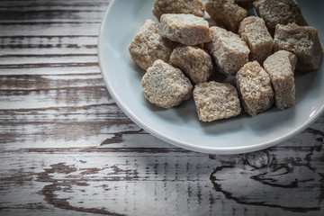 Vintage sugar cubes plate on wooden board