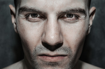 Portrait of a European male close-up with bristles on a gray background