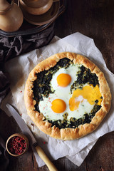 Homemade spinach pie galette with eggs