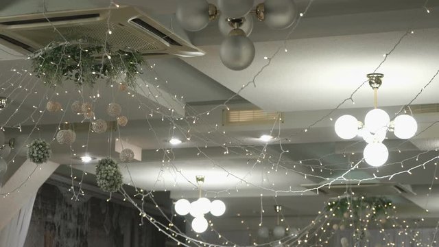 Elegant design of the ceiling in the restaurant in a silver style with led lights