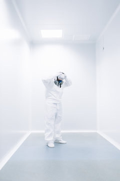 Scientist putting on protective mask