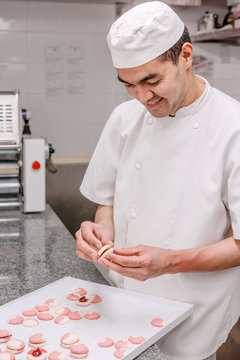 p&acirc;tissier pr&eacute;pare des macarons