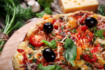 Fresh pizza with tomatoes, cheese and mushrooms on wooden table closeup