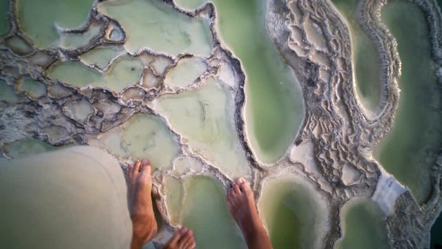 pov, young couple walking together on calcium terrace,close up legs, Mexico Hierve el Agua