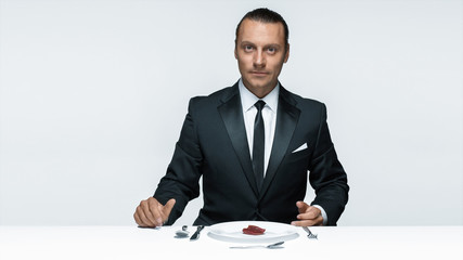 Bloody Halloween theme: crazy man with a knife, fork and meat