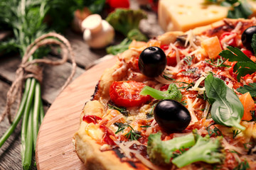Fresh pizza with tomatoes, cheese and mushrooms on wooden table closeup