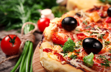 Fresh pizza with tomatoes, cheese and mushrooms on wooden table closeup