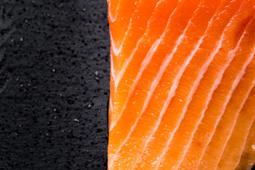 Close up of salmon fillet. Macro with dark space for text