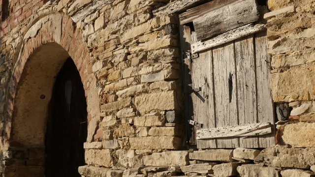 Weathered stone building facade details - Ancient wine cellar wooden window and doors