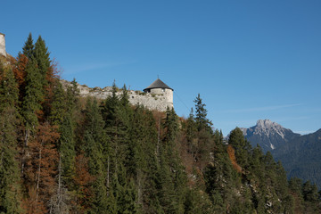 Fototapeta na wymiar A tower above the trees of Ehrenberg Castle in Austria next to Highline 179