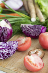 Closeup of fresh vegetables on wooden table.