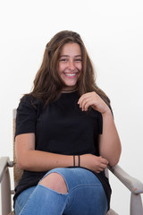 Young woman sitting in the studio with straight long hair sitting