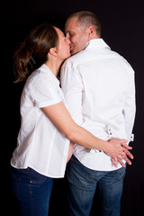 Smiling couple waiting for a child leans to each other