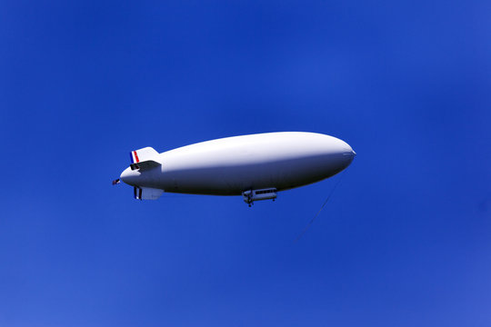 A zeppelin flying in the blue sky