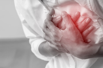 Man clutching his chest, acute pain possible heart attack.Heart attack symptom-Health concept.