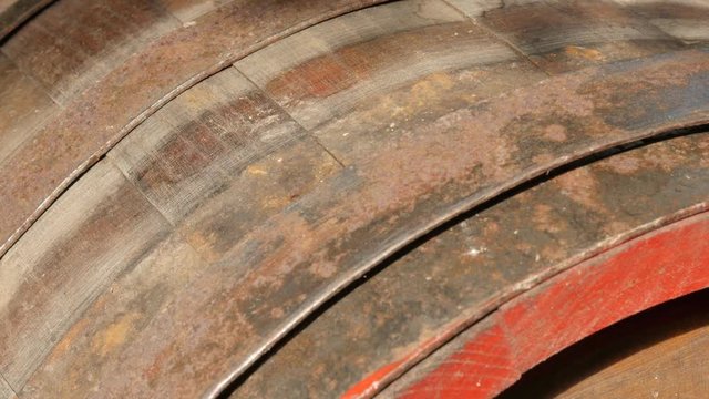 Old wooden planks and metal hoops of wine barrel close-up 