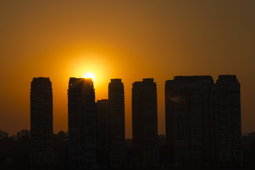 Fototapeta na wymiar Sunset landscape between buildings