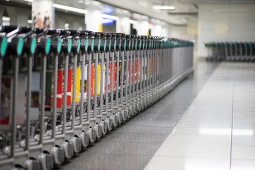 Row of luggage carts at the airport for transporting luggage.