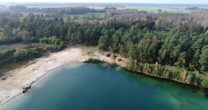Flight over the middle of a lake with complete rotations around the vertical axis, aerial view, L&uuml;neburger Heide, Lower Saxony, Germany