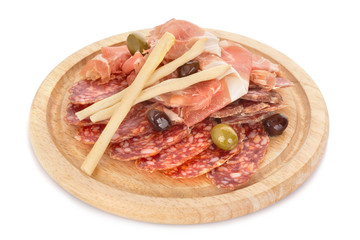 Dry-cured pork slices on wooden plate isolated