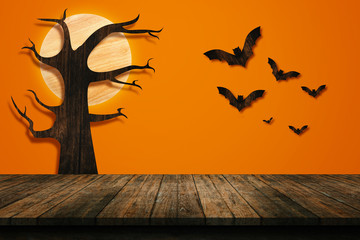 Halloween holiday concept. Wooden old table in a shape of wooden bats on the orange wall. For your product placement or montage with focus to the table top in the foreground. shelves