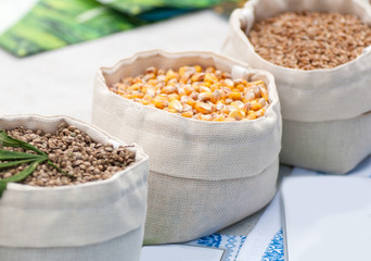 organic wheat, corn and hemp in white sacks