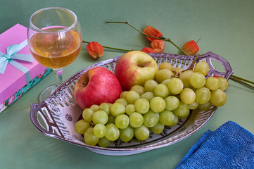 Glasses of wine and grapes on yellow background