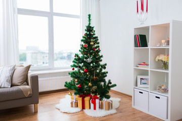 artificial christmas tree and presents at home