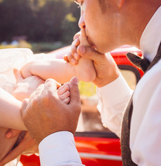 Father kisses daughter's foot while mom holds her